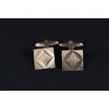 A pair of 9ct gold square cufflinks with engraved design