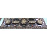 A Nepalese/Tibetan wooden plaque with applied copper and brass Buddha and dragon decoration set