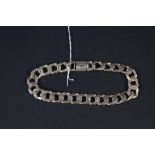 A 9ct gold flat link bracelet with engraved pattern