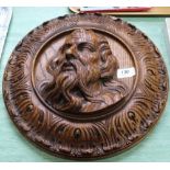 A Victorian circular carved oak panel of a bearded man,