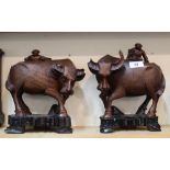 A pair of Chinese carved hardwood boys on buffaloes (chipped horns)