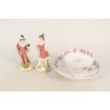 An 18th Century spiral fluted floral tea bowl and saucer (rim chip) plus a pair of Derby figurines