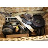 A fishing basket containing vintage fishing reels