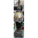 A glass and metal table lamp with cherub and floral decoration