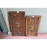 A pair of Victorian carved oak panels with foliate and mans head decoration,