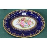 A 19th Century English oval plate with blue and gilt border and floral decoration
