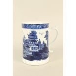 A Lowestoft tankard with river scenes, pagodas blue wash and deep cell border pattern,