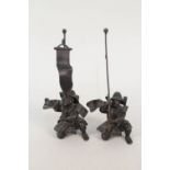 A pair of Japanese metal samurai warriors holding flagstaffs,