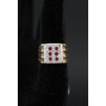 A gold gents signet ring set with rubies and diamonds,