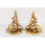A pair of ornate Florentine carved and gilded wooden wall brackets of foliate design