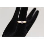 An 18ct gold diamond solitaire ring, approx 1ct set with three small diamonds either side,