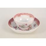 A Chinese porcelain tea bowl and saucer with flower and ribbon pattern and deep pink border (saucer