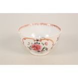 A Chinese porcelain tea bowl with rose/dahlia in cartouche