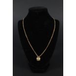 A 9ct gold chain with a small pendant attached