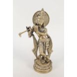 An Indian brass figure of Krishna playing a pipe,