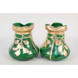 A pair of green glass and gilt floral vases