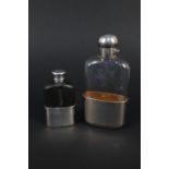 A silver and glass hip flask with detachable silver cup, leather top (as found),