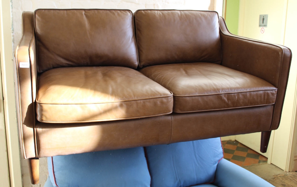 A stylish modern brown leather two seater sofa on tapered feet