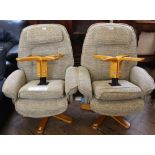 A pair of Relaxateeze recliners with beige upholstery and matching footstools