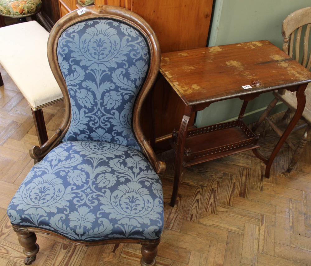 An Edwardian occasional table with galleried under tier and a Victorian upholstered balloon back