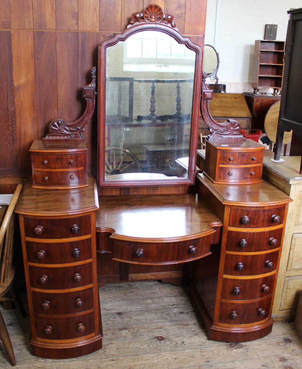 A Victorian mahogany Duchess dressing table flanked by ten drawers with large mirrored upstand of