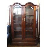 A substantial mahogany two door display cabinet