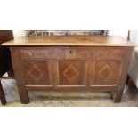 An early 19th Century carved coffer with inlaid panels