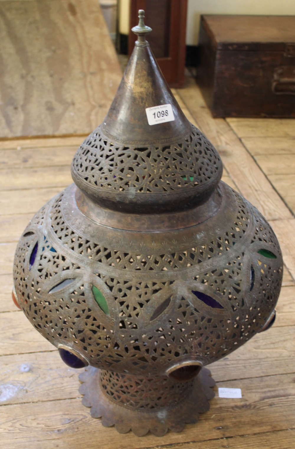 A Moroccan pierced brass lantern with coloured glass detail