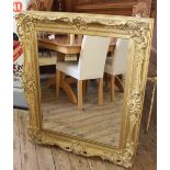 A large rectangular ornate gilt wall mirror