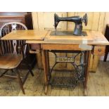 An oak Singer sewing machine with treadle,