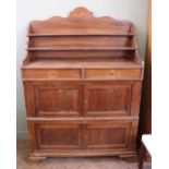 A large French four drawer and two door cupboard with shaped top shelved upstand