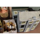 A wooden dolls house and furniture