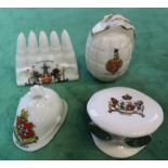 Four items of WWI era crested china including a grenade and a clip of bullets