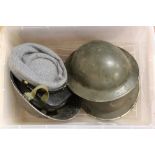 A quantity of military 'head wear' including British tin helmets (one dated 1939)