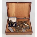 A wooden box containing tank regiment badges with military issue jack knife etc