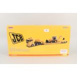 A boxed Corgi Man TGA Nooteboom low loader and JCB backhoe loader 3CX