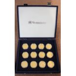 A cased set of twelve Westminster Titanic Centenary gold plated medallions