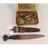 A Queen Mary Christmas tin and contents with a small African dagger