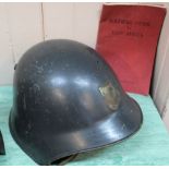 A Swiss 'model M18' helmet with a booklet 'Soldiers Guide to East Africa'