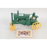 A cast iron tractor plus three WWI silk postcards