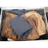 A tin trunk containing various uniforms including leather jerkins and a pair of 1944 dated W.A.A.F.