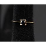 A 9ct gold ring set with black stone,