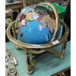 A terrestrial globe on brass gymbal with stone and mother of pearl inlays