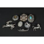 A small quantity of silver and white metal brooches including one in the form of a stag,