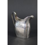 A Georgian silver cream jug with engraved decoration,