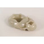 A finely carved Chinese Celadon jade scholars brush washer carved as a lily with trailing flower