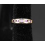 A 9ct gold ring set with square cut amethyst interspaced with small diamonds either side of shank,