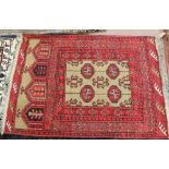 A Persian red ground rug with tree motifs,