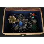 A jewellery box with costume jewellery and two silver brooches