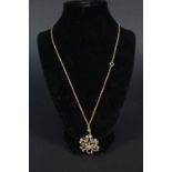An Art Nouveau style 9ct gold pendant set with blue stones and seed pearls on 9ct gold chain